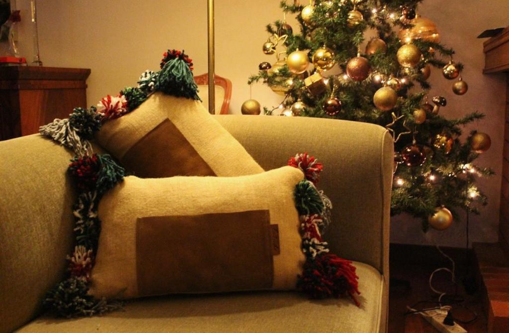 Onor (Special Christmas Edition) - cushion with wool pom poms and a leather pocket
